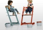 two-wooden-colorful-high-chairs-with-twins-sitting-on